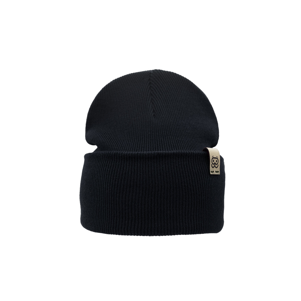 A black knit Organic Beanie by Goggleface, featuring a folded brim with a small beige tag displaying a black design. This timeless accessory is perfect for any wardrobe and is showcased against a plain white background.