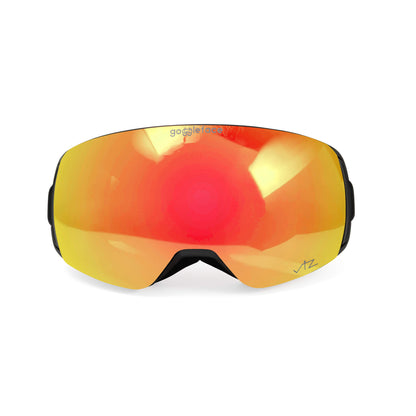 The Goggleface Switch Line ski goggles feature a sleek black frame and reflective, orange-tinted lenses that offer optical excellence for winter sports. The reflection on the lenses shows bright light sources. These goggles are also compatible with Switch Line accessory lenses for versatile performance.